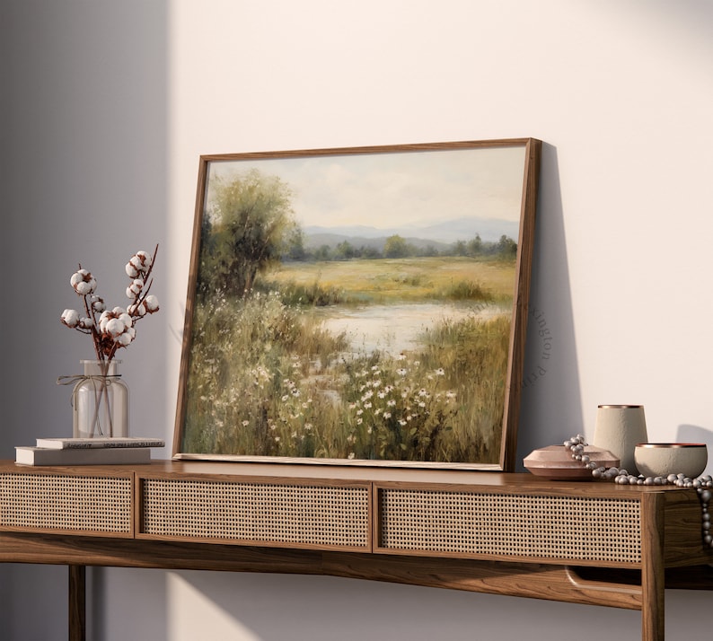 Vintage Spring wall art wildflower field art print landscape painting. It is displayed in an antique frame. This Spring decor can also be Easter decor. The painting features intricate brushwork and colors. The shop name Lexington Prints is written