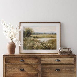 Vintage Spring wall art wildflower field art print landscape painting. It is displayed in an antique frame. This Spring decor can also be Easter decor. The painting features intricate brushwork and colors. The shop name Lexington Prints is written