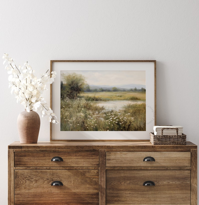 Vintage Spring wall art wildflower field art print landscape painting. It is displayed in an antique frame. This Spring decor can also be Easter decor. The painting features intricate brushwork and colors. The shop name Lexington Prints is written
