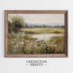 Vintage Spring wall art wildflower field art print landscape painting. It is displayed in an antique frame. This Spring decor can also be Easter decor. The painting features intricate brushwork and colors. The shop name Lexington Prints is written