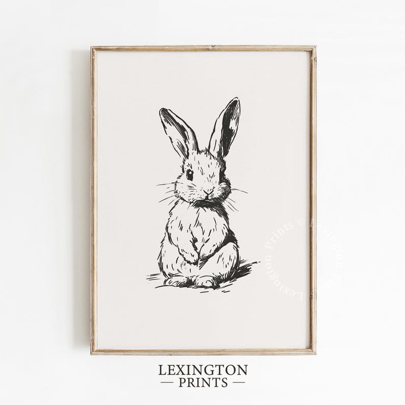 Vintage black sketch wall art of a cute easter bunny rabbit. The sketch art print features thick black sketch work against a simple off white background. The sketch is a minimalist drawing fits an aesthetic for spring decor, easter decor, nursery decor, and rustic farmhouse decor. The shop name LexingtonPrints is written below