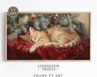 May include: A ginger cat sleeps peacefully under a decorated Christmas tree. The cat is lying on a red velvet cushion with its paws tucked under its body. The tree is decorated with gold ornaments and lights.
