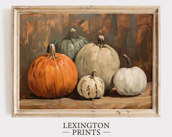 Puede incluir: Una pintura de bodegón con cinco calabazas en varios tonos de verde, blanco y naranja. Las calabazas están dispuestas sobre una superficie de madera y están iluminadas desde el frente. La pintura está enmarcada en un marco de madera claro.