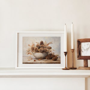 Fall Vintage fall pinecone decor painting oil painting art print displayed in an antique frame against a white background. The painting features intricate brushwork and colors. The shop name Lexington Prints is written out beneath the wall art frame