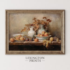 May include: A framed still life print featuring a wooden table laden with peaches, grapes, and white ceramic pitchers. The artwork has a vintage aesthetic with warm, earthy tones and the text "LEXINGTON PRINTS" at the bottom.