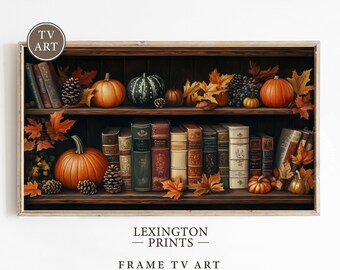 Könnte beinhalten: Gerahmter Druck eines Bücherregals, das für den Herbst dekoriert ist. Die Regale sind mit alten Büchern, Kürbissen, Tannenzapfen und Herbstblättern gefüllt. Der Text "LEXINGTON PRINTS - FRAME TV ART" ist unten zu sehen.