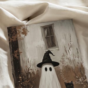 Vintage Halloween wall art print of a cute white ghost dressed as a witch in a witch hat next to his cute black cat in a fall scene. The Halloween painting features moody fall colors of black, white and brown hues along with intricate brushwork. The artwork embodies themes of vintage Halloween wall decor, dark farmhouse decor, dark cottagecore decor, gothic decor, and halloween wall decor. The shop name Lexington Prints is written below