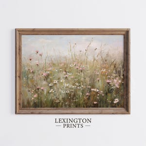 Vintage Spring wall art wildflower field landscape painting art print displayed in an antique frame, featuring pink and beige wildflowers up close. This Spring decor can also be Easter decor. The painting features intricate brushwork and colors. The shop name Lexington Prints is written below.