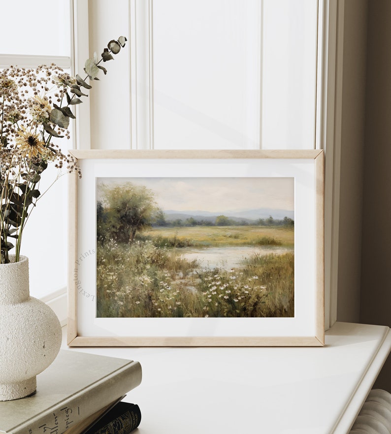 Vintage Spring wall art wildflower field art print landscape painting. It is displayed in an antique frame. This Spring decor can also be Easter decor. The painting features intricate brushwork and colors. The shop name Lexington Prints is written