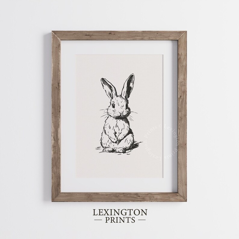 Vintage black sketch wall art of a cute easter bunny rabbit. The sketch art print features thick black sketch work against a simple off white background. The sketch is a minimalist drawing fits an aesthetic for spring decor, easter decor, nursery decor, and rustic farmhouse decor. The shop name LexingtonPrints is written below