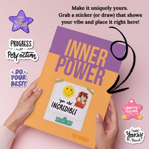 May include: A journal with the words "Inner Power" and a sticker that says "You are Incredible" is held by a person. The journal is orange and purple. Surrounding the journal are stickers with phrases like "Shine Like a Star" and "Do Your Best!"
