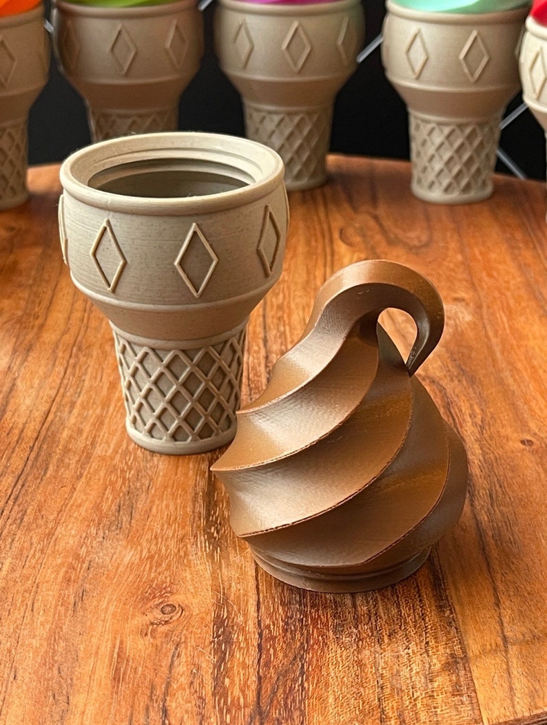 May include: A brown swirl-shaped ice cream cone with a beige waffle cone.