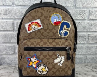 Coach X Peanuts Snoopy West Backpack In Signature Canvas With Varsity Patches