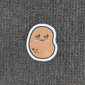 May include: A brown potato sticker with a cartoon face. The potato has a surprised expression with raised eyebrows and small pink cheeks. The potato has a few brown spots on it.