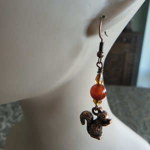 Copper woodland earrings with squirrel charms and orange-red jade beads