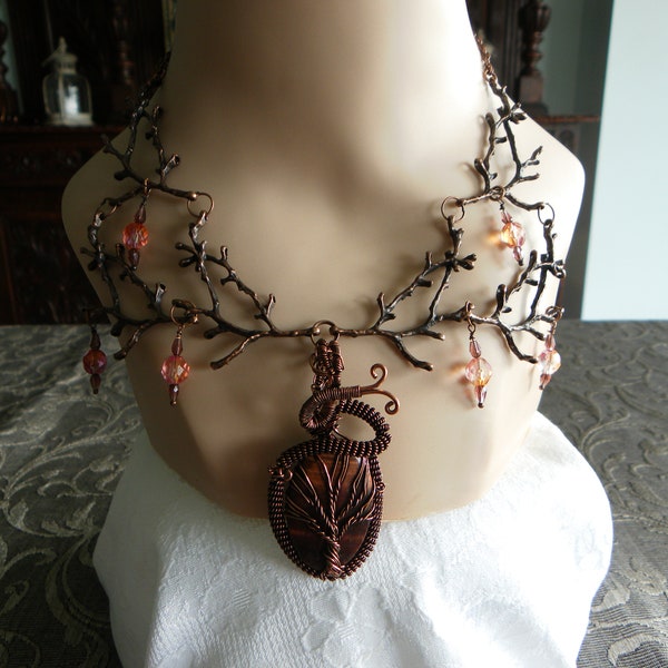 Copper branch necklace with peach crystal bead drops and wire-wrapped tiger iron tree of life pendant