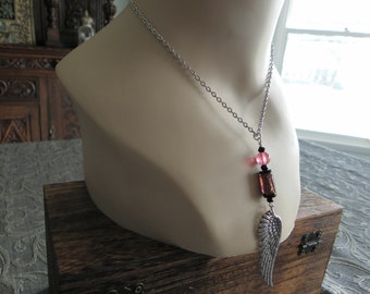 Silver wing pendant necklace with pink lampwork beads