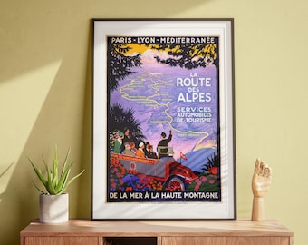 May include: A vintage travel poster advertising a scenic route through the French Alps. The poster features a map of the route, a car full of passengers, and the text "La Route des Alpes" in a decorative font.