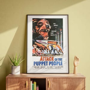 May include: A vintage movie poster for the film "Attack of the Puppet People". The poster features a menacing, snarling creature with a knife in its paw, and a group of people running away in fear. The text on the poster reads "Doll Dwarfs", "Crushing Giant Beasts!" and "Attack of the Puppet People".
