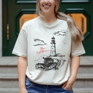 The Lighthouse Graphic T-Shirt, Coastal T-shirt, Ocean Lover Gift, Unique Lighthouse Outfit, Beach Vibes Tee, Ocean Wave Shirt