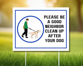 May include: White sign with a blue border and a cartoon illustration of a person walking a dog. The sign reads "Please be a good neighbour clean up after your dog."