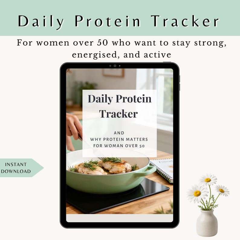 May include: A digital tablet displays a Daily Protein Tracker guide with text reading Daily Protein Tracker and Why Protein Matters for Woman Over 50. The screen shows a light green pan with cooked chicken and herbs on a black stovetop surface.