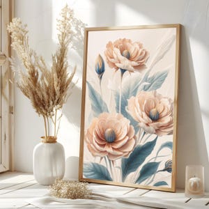 May include: A framed floral print featuring three large, pale pink flowers with blue centers. The flowers are surrounded by blue-green leaves on a cream background.