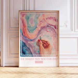 May include: A watercolor painting of a hand holding a tiny person standing on a colorful, abstract background. The text "THE SMALLEST MAN WHO EVER LIVED" is at the bottom of the painting.