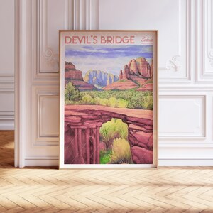 May include: A vintage travel poster featuring a watercolour illustration of Devil's Bridge in Sedona, Arizona. The poster has a red, white and blue colour scheme and features a scenic view of the natural rock formation.