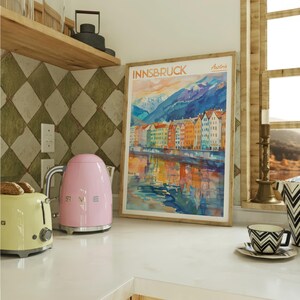 a kitchen counter with a pink toaster and a painting on the wall