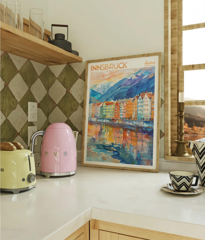 a kitchen counter with a pink toaster and a painting on the wall