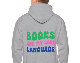 May include: A gray hooded sweatshirt with the text "BOOKS ARE MY LOVE LANGUAGE" printed on the back in green, pink, and blue letters.