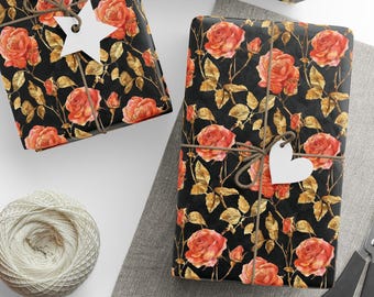 May include: Gift-wrapped boxes with a black background and a floral rose pattern in shades of orange and gold. Each box is tied with twine and a white tag. A ball of twine, scissors, and blank tags are also visible.