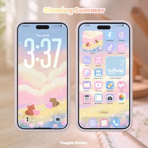 May include: Two smartphones displaying a digital theme titled Glowing Summer. The screens feature a pastel sky, clouds, and brown bears holding pink hearts. The interface includes custom app icons, a calendar widget, and a clock display.