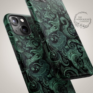 May include: Two black phone cases with a green paisley design. The cases have a glossy finish and a detailed, swirling pattern. The Underground Garden logo is visible in the background.