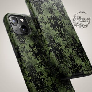 May include: Two green and black phone cases with a damask pattern. The cases are made of a hard plastic material and have a glossy finish. The text "THE UNDERGROUND GARDEN" is printed on the back of one of the cases.