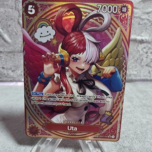 May include: A One Piece trading card featuring the character Uta with red and white hair, wearing headphones. The card has a gold border, a 7000 power rating, and text stating: On Play If your Leader is Uta, draw 2 cards. Then, play up to 1 Character card.