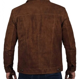 May include: A brown suede jacket with a button-up front and long sleeves. The jacket has a classic denim style.