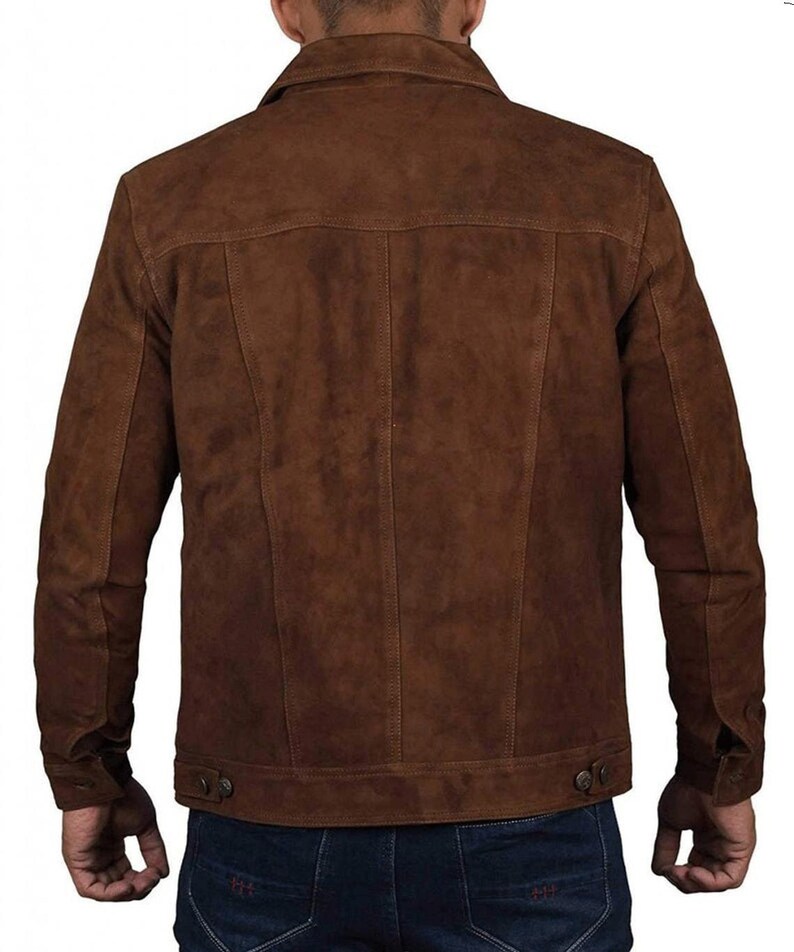 May include: A brown suede jacket with a button-up front and long sleeves. The jacket has a classic denim style.
