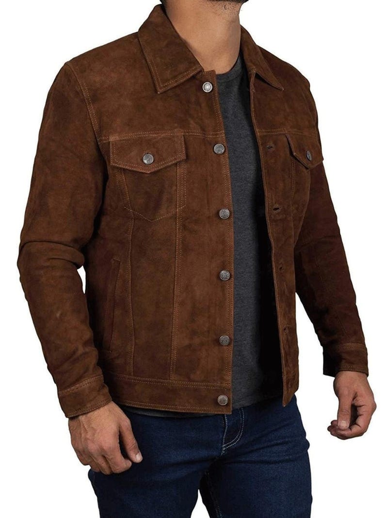 May include: A brown suede jacket with a button-up front and two flap pockets. The jacket has a classic denim style.