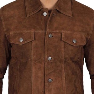 May include: A brown suede jacket with a button-up front and two flap pockets. The jacket has a classic denim style.