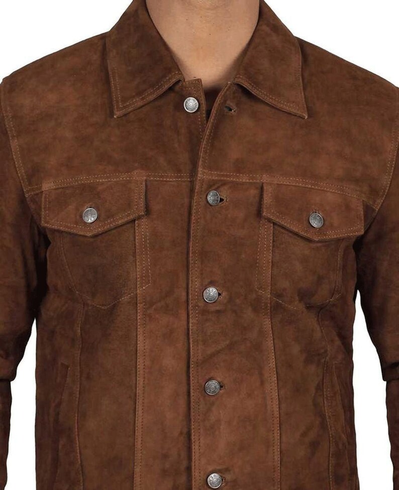 May include: A brown suede jacket with a button-up front and two flap pockets. The jacket has a classic denim style.