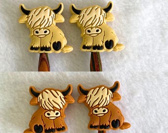 May include: Four wooden knitting needles with cute highland cow toppers. Two are brown and two are cream colored.