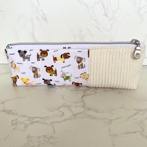 Slim pencil case, length 10.5” in cream jumbo cord and dog design.  Double pointed needles, crochet hook, notions, storage. Premium handmade