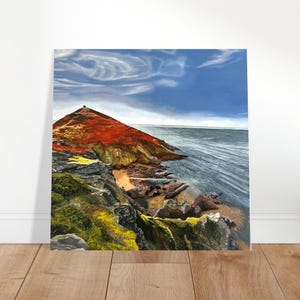 May include: A square painting depicting a coastal landscape with a prominent red-toned hill rising above a rocky shoreline. The scene features dark grey rocks, patches of vibrant green and yellow vegetation, and a deep blue sea under a cloudy sky.