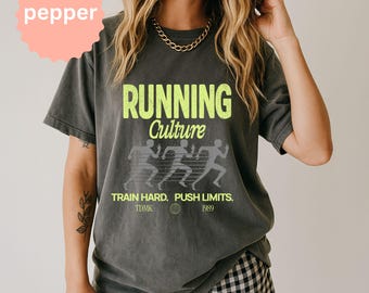 May include: Dark gray t-shirt with the words "RUNNING Culture" in neon green. Below the text are three running figures in gray. The shirt also has the text "TRAIN HARD. PUSH LIMITS. TDMK 1989."