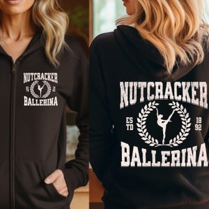 May include: Black zippered hoodie with a white graphic print of a ballerina silhouette and the text "Nutcracker Ballerina" with the years "ESTD 1892".