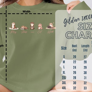 Pode incluir: Tabela de tamanhos Gildan 18000 para sweatshirts. A tabela mostra os tamanhos S a 4XL com medidas em polegadas para o peito, o comprimento e o comprimento da manga.