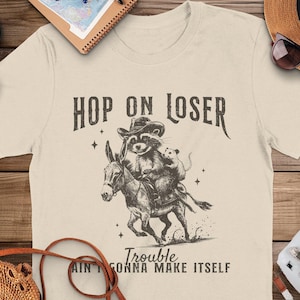 Western Funny Raccoon Shirt, Hop On Loser Trouble Ain't Gonna Make Itself Tee-Shirt, Cowboy Opossum T-shirt, Vintage Donkey Tee Gift