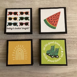 May include: Four square cards with black borders. One card features sunglasses with the text "today's lookin' bright!". Another shows a watermelon slice. A third has a rainbow design, and the last displays roller skates with the text "let the good times roll".